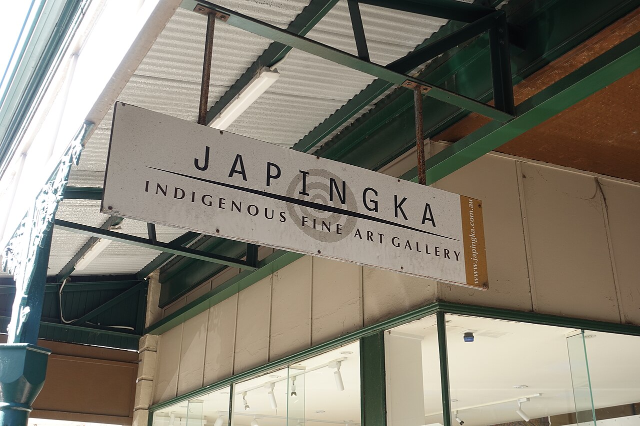 Japingka Aboriginal Art Gallery sign hanging above the High Street footpath in Fremantle.