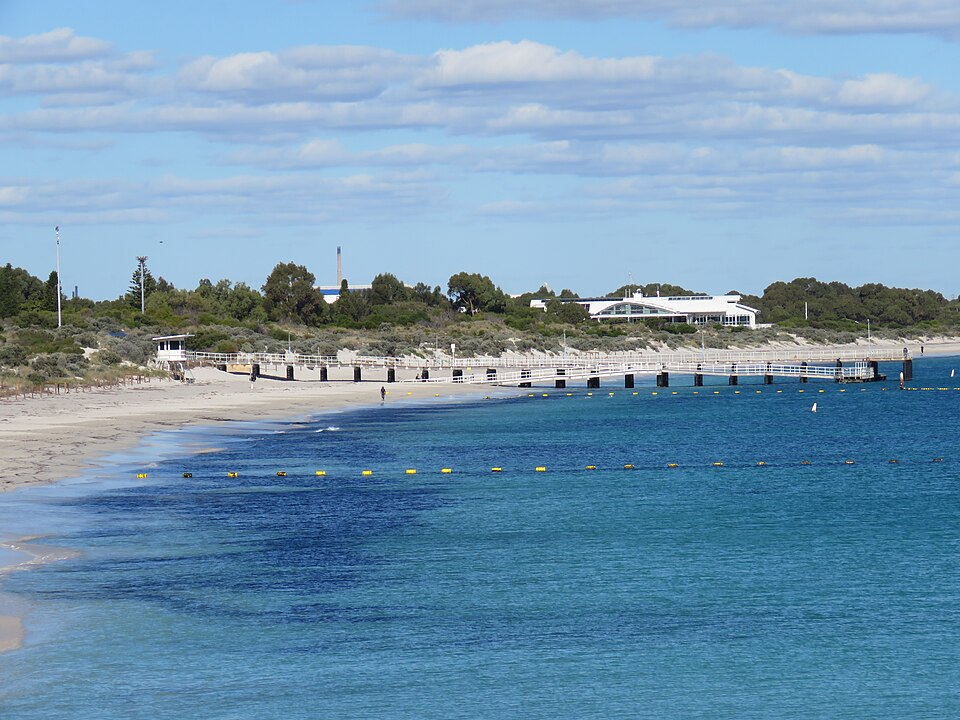 White-railed Coogee Beach Jetty beside the sand and blue water.