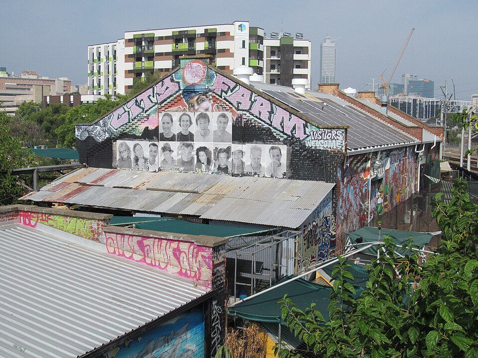 Painted exterior of Perth City Farm seen above roofs in East Perth.