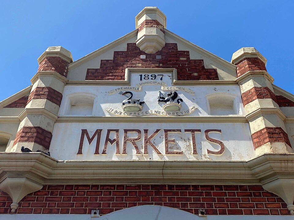 The Fremantle Markets sign on the historic brick facade.