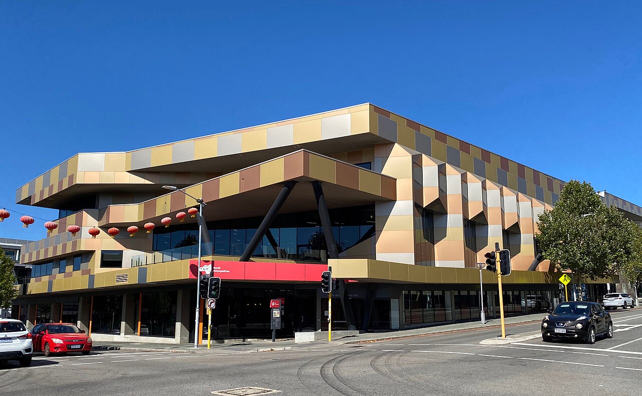 Tan and grey facade of a North Metropolitan TAFE campus building at an Aberdeen Street intersection.
