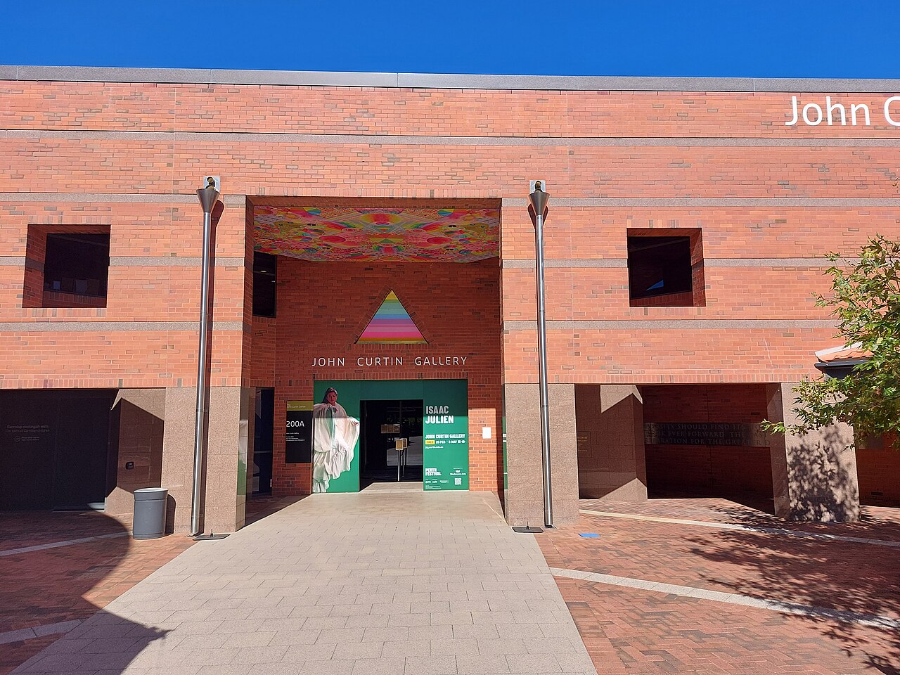 Red-brick entrance to John Curtin Gallery, with the gallery name above the doors at Building 200A.