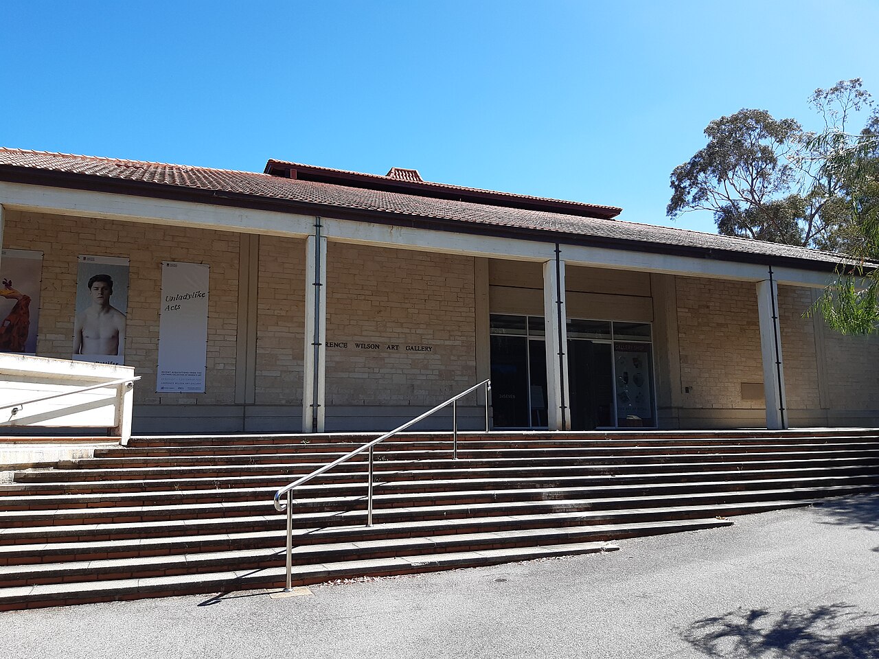 Pale stone frontage and wide entrance steps beneath the covered terrace of Lawrence Wilson Art Gallery.