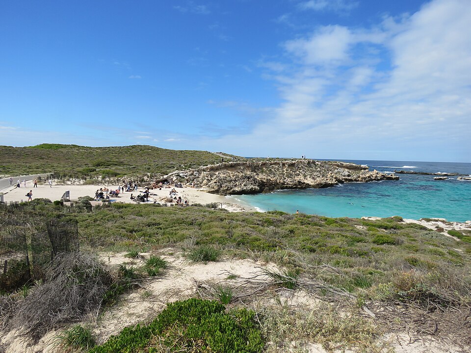 Sandy Little Salmon Bay framed by limestone rock and vegetation