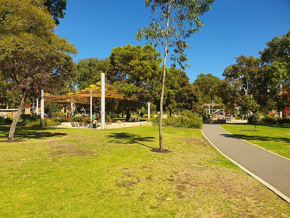Lawn, trees and sheltered park paths at Wellington Square